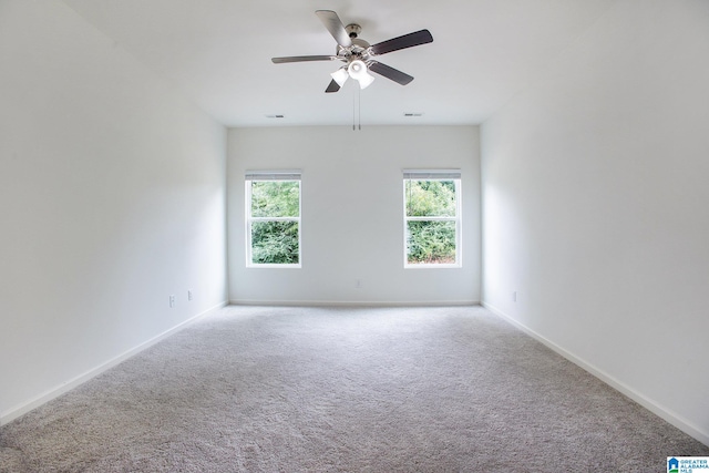 spare room with light colored carpet and ceiling fan