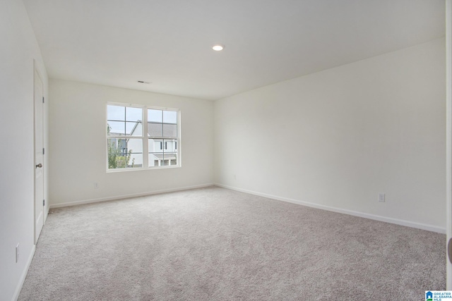 spare room with light colored carpet