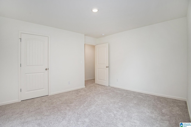 interior space with light carpet and a closet