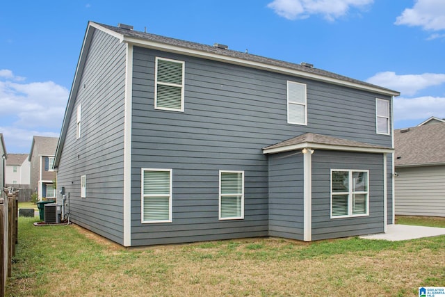 back of house with a lawn, a patio, and central air condition unit