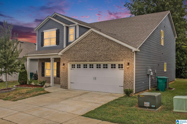 craftsman inspired home featuring a yard and a garage