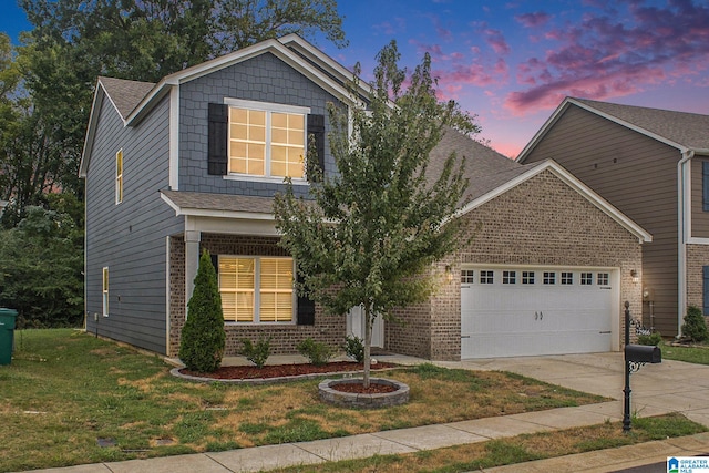 view of front of house featuring a lawn and a garage