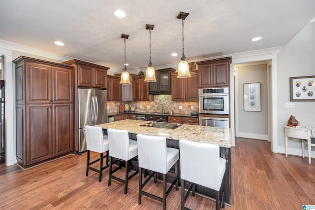 kitchen featuring sink, stainless steel appliances, dark wood-type flooring, and tasteful backsplash