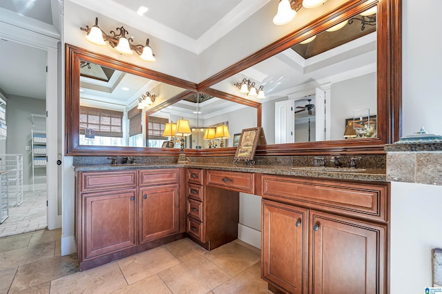 bathroom with ornamental molding, ceiling fan, a raised ceiling, and vanity