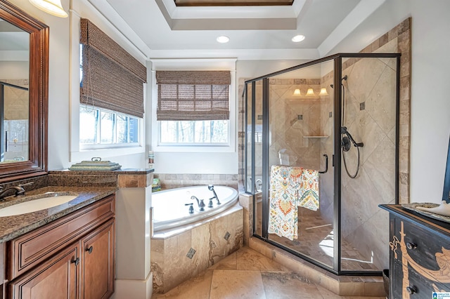 bathroom with vanity, plus walk in shower, and a raised ceiling