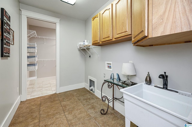 laundry room featuring cabinets, light tile patterned flooring, sink, electric dryer hookup, and hookup for a washing machine