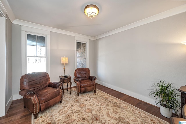 sitting room with wood-type flooring and crown molding