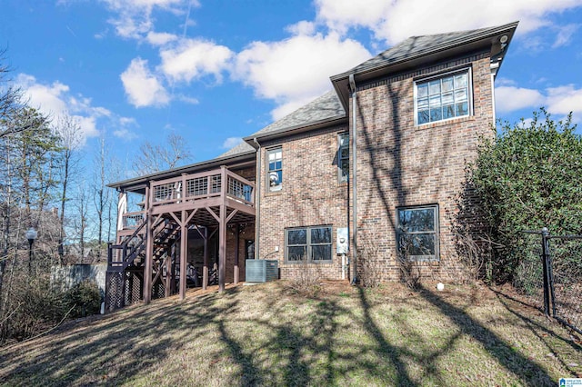 view of front of property featuring a front yard, cooling unit, and a wooden deck