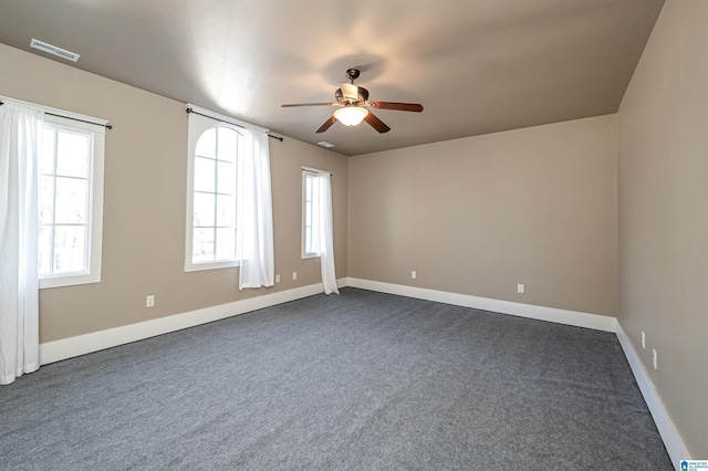 empty room with ceiling fan and carpet