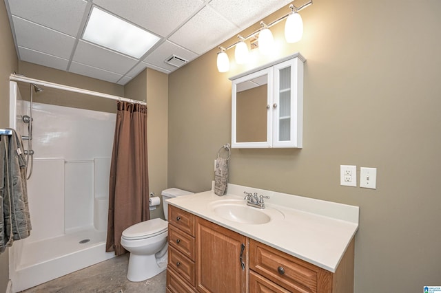 bathroom featuring walk in shower, a paneled ceiling, vanity, and toilet