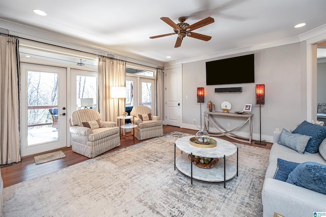 living room featuring ceiling fan, hardwood / wood-style flooring, french doors, and crown molding