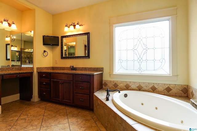 bathroom featuring tile patterned flooring, vanity, and a relaxing tiled tub