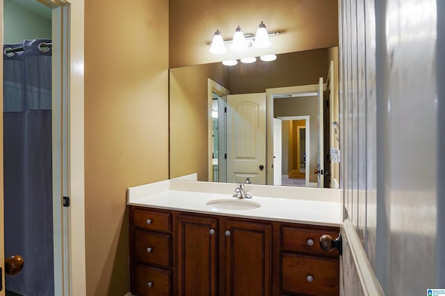 bathroom featuring curtained shower and vanity