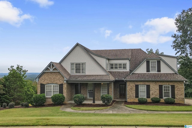 view of front of house with a porch and a front yard