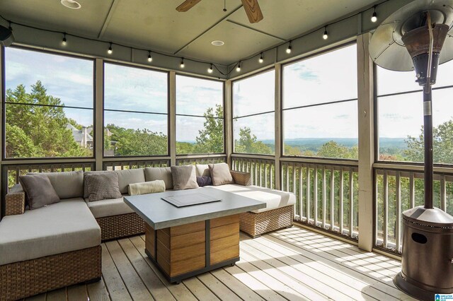 sunroom featuring ceiling fan