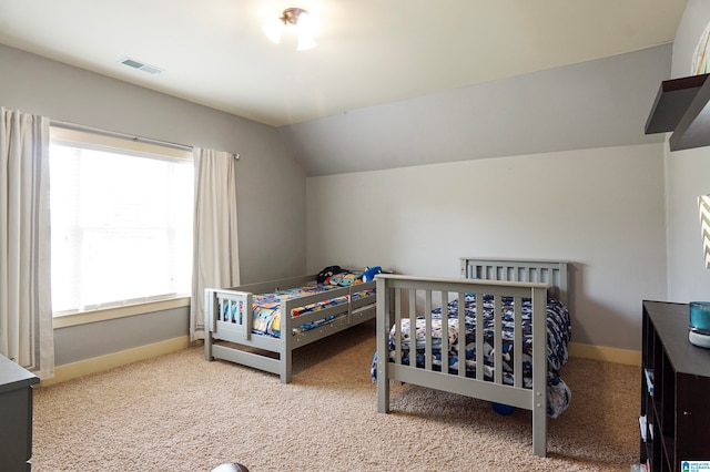 bedroom featuring carpet flooring and lofted ceiling