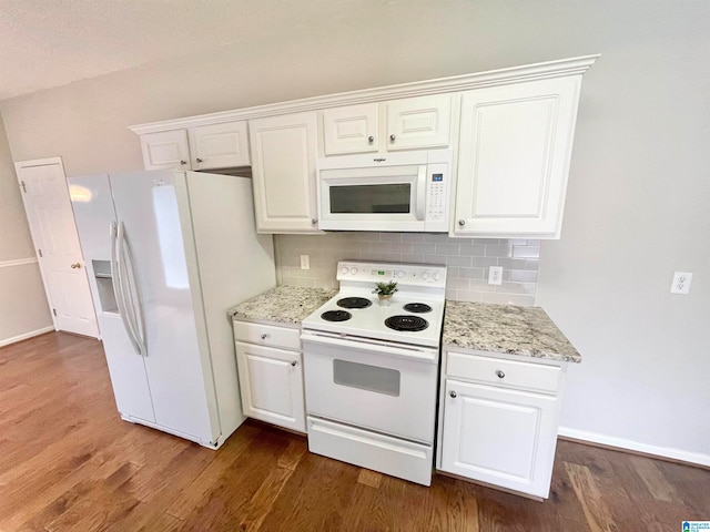 kitchen with white cabinets, white appliances, dark hardwood / wood-style floors, and decorative backsplash