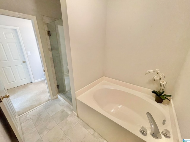 bathroom featuring tile patterned flooring and independent shower and bath