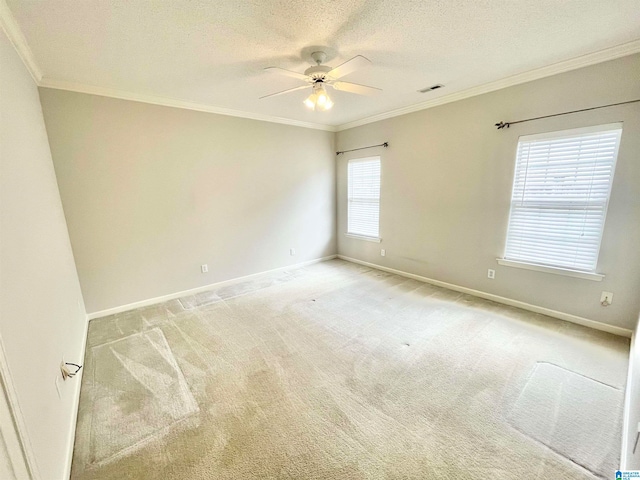 carpeted empty room featuring crown molding, a textured ceiling, plenty of natural light, and ceiling fan