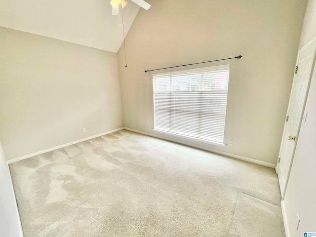 carpeted empty room featuring ceiling fan and high vaulted ceiling