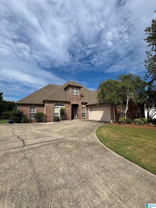 view of front of house featuring a front yard and a garage