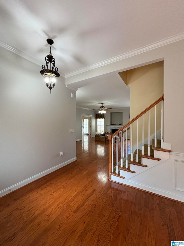 empty room with ornamental molding, hardwood / wood-style flooring, and ceiling fan