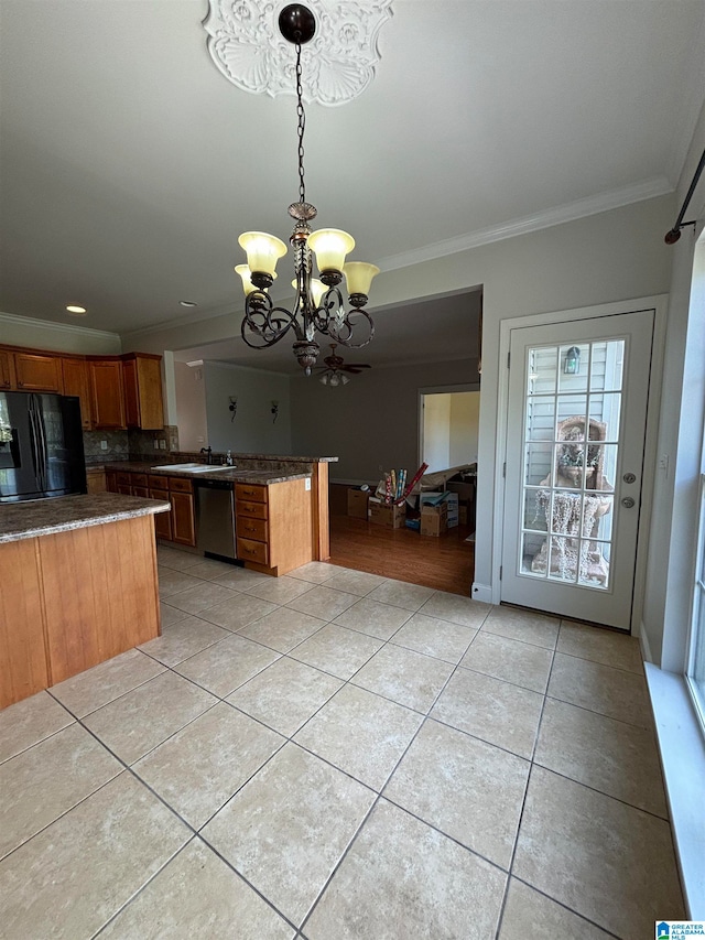 kitchen with black refrigerator, dishwasher, an inviting chandelier, hanging light fixtures, and light tile patterned flooring