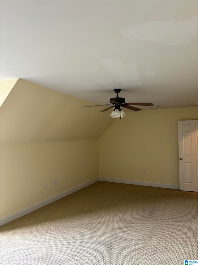 additional living space with vaulted ceiling, ceiling fan, and carpet floors