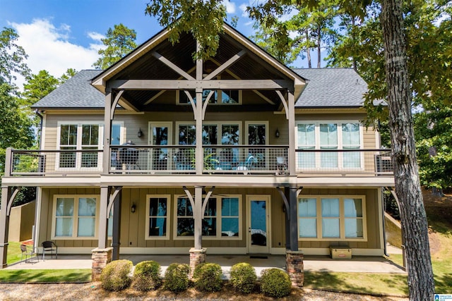 rear view of property featuring a patio area and a balcony