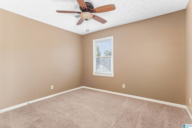 carpeted empty room with a textured ceiling and ceiling fan