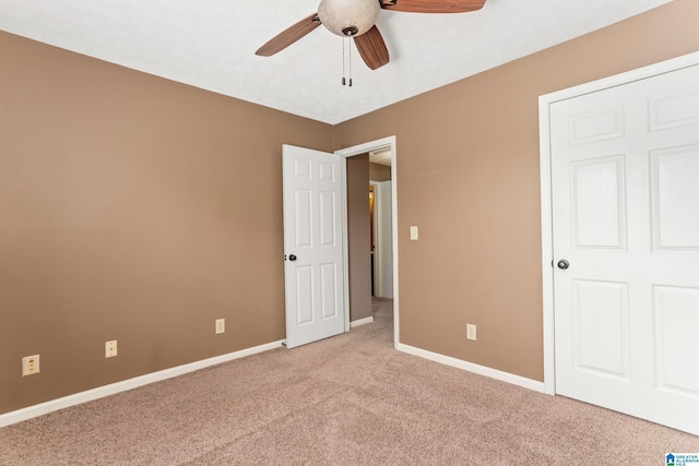 unfurnished bedroom featuring ceiling fan and light colored carpet