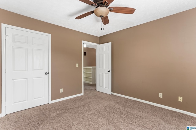 unfurnished bedroom with a closet, ceiling fan, and carpet