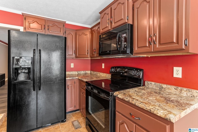 kitchen featuring crown molding, black appliances, and a textured ceiling