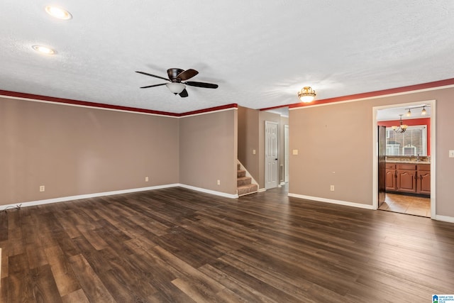 spare room featuring ceiling fan with notable chandelier, a textured ceiling, and hardwood / wood-style flooring