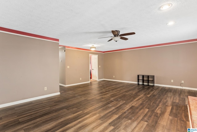 spare room with a textured ceiling, ceiling fan, and dark hardwood / wood-style floors