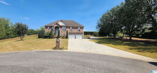 view of front of house featuring a garage and a front lawn