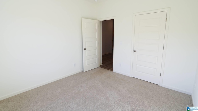 unfurnished bedroom featuring light colored carpet