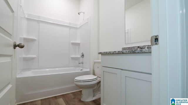 full bathroom featuring vanity, wood-type flooring, shower / bathtub combination, and toilet