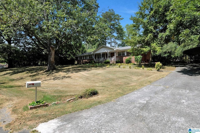 view of front of house with a porch and a front yard