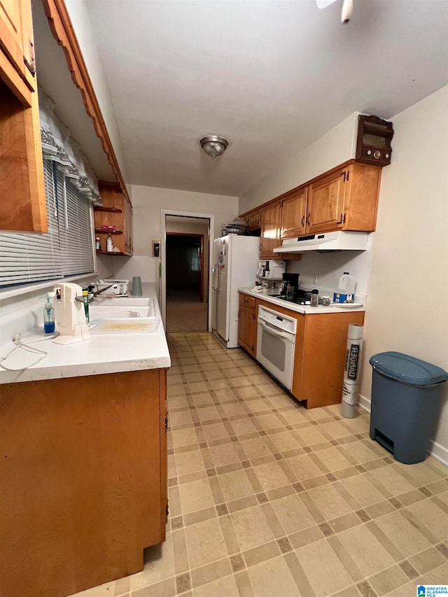 kitchen featuring sink and white appliances