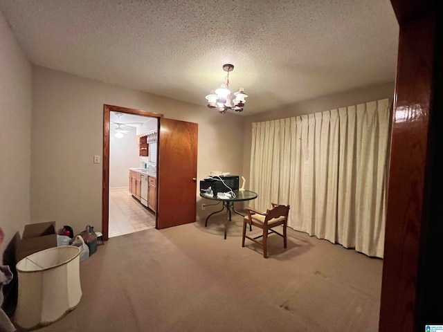 living area with a textured ceiling, light carpet, and a chandelier