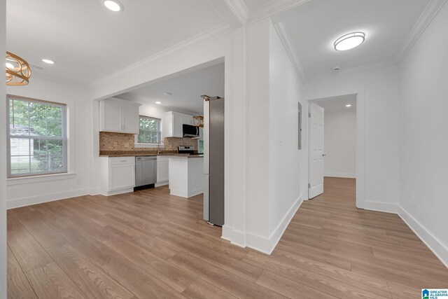 unfurnished dining area with crown molding, a notable chandelier, and hardwood / wood-style flooring