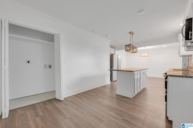 kitchen with a center island, white cabinetry, and light hardwood / wood-style floors