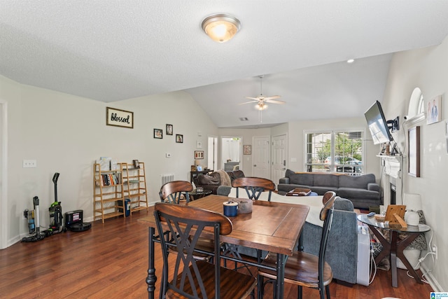 dining space featuring ceiling fan, lofted ceiling, and dark hardwood / wood-style floors