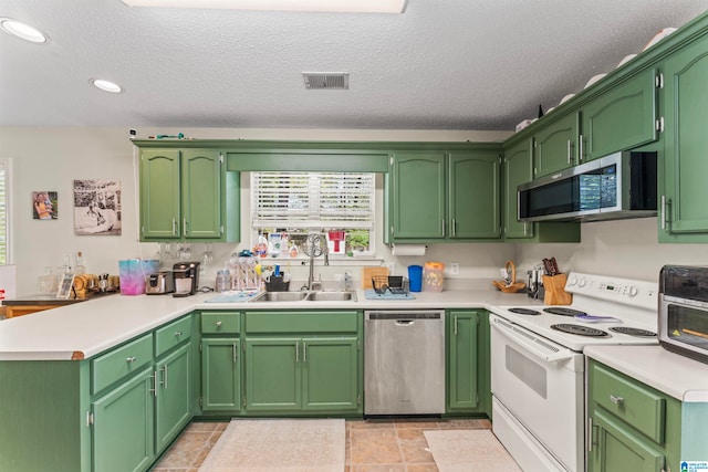 kitchen with green cabinetry, stainless steel appliances, plenty of natural light, and sink