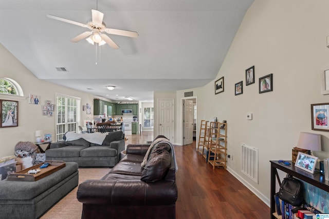 living room featuring ceiling fan, vaulted ceiling, and hardwood / wood-style floors