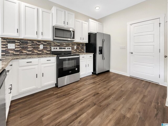 kitchen featuring appliances with stainless steel finishes, white cabinetry, backsplash, and dark hardwood / wood-style floors