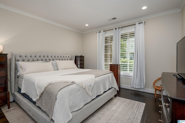 bedroom featuring crown molding and dark hardwood / wood-style floors