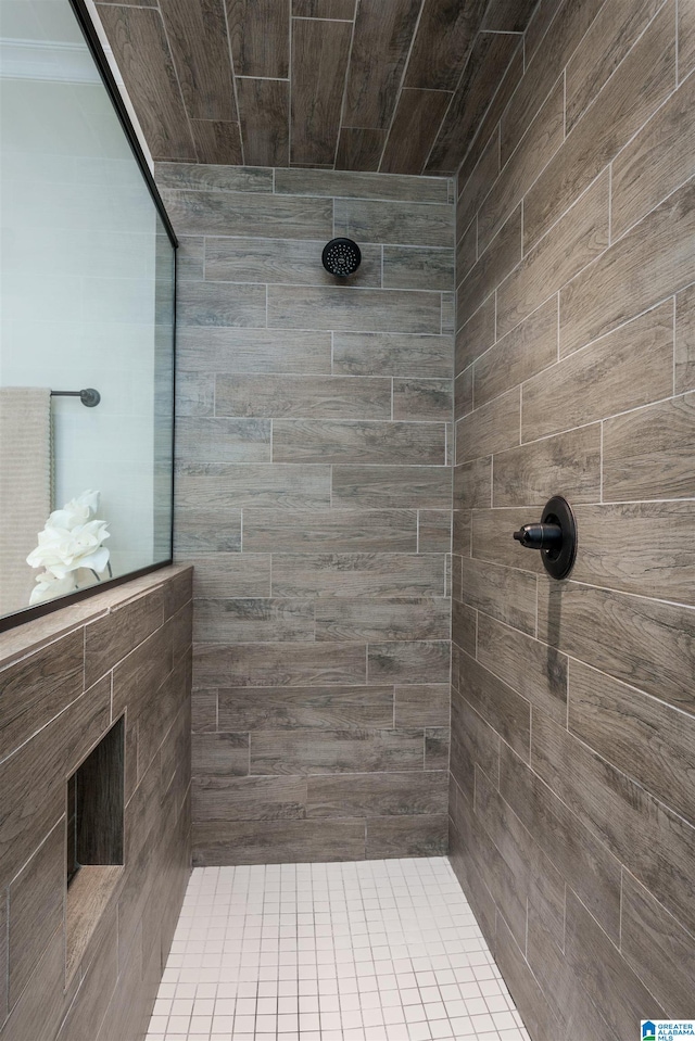 bathroom featuring tiled shower and ornamental molding