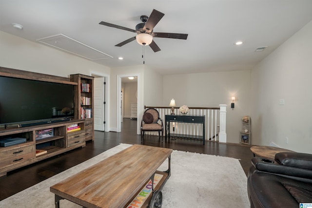 living room featuring dark wood-type flooring and ceiling fan